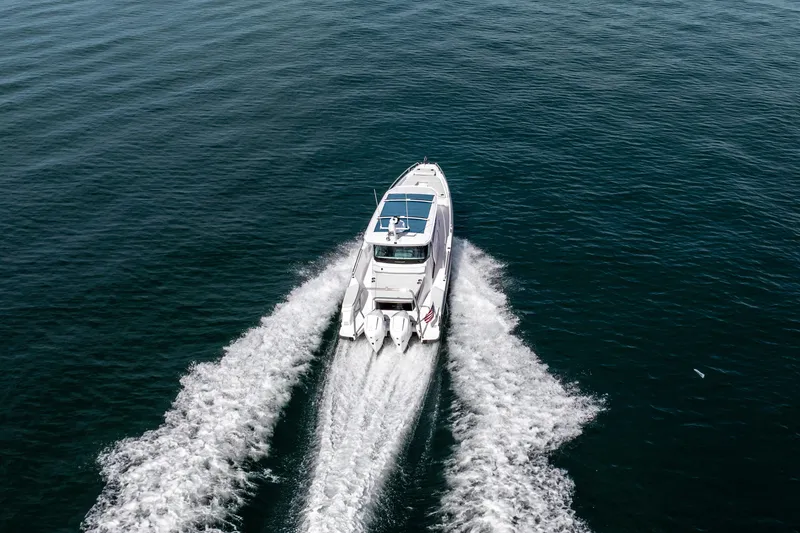 Slide: The Image of 2027 Axopar 29 XC Cross Cabin cruising on open water, aerial view. - 3