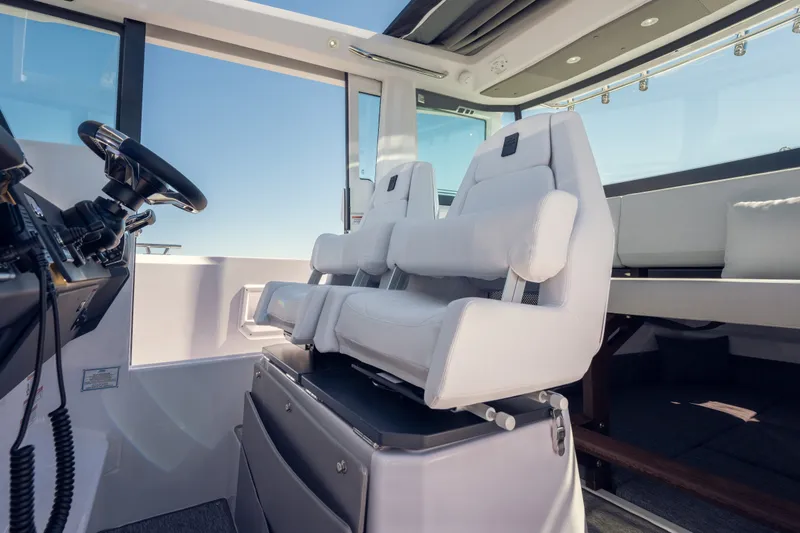 Slide: The Image of 2027 Axopar 29 XC Cross Cabin interior with modern seating and steering wheel. - 16