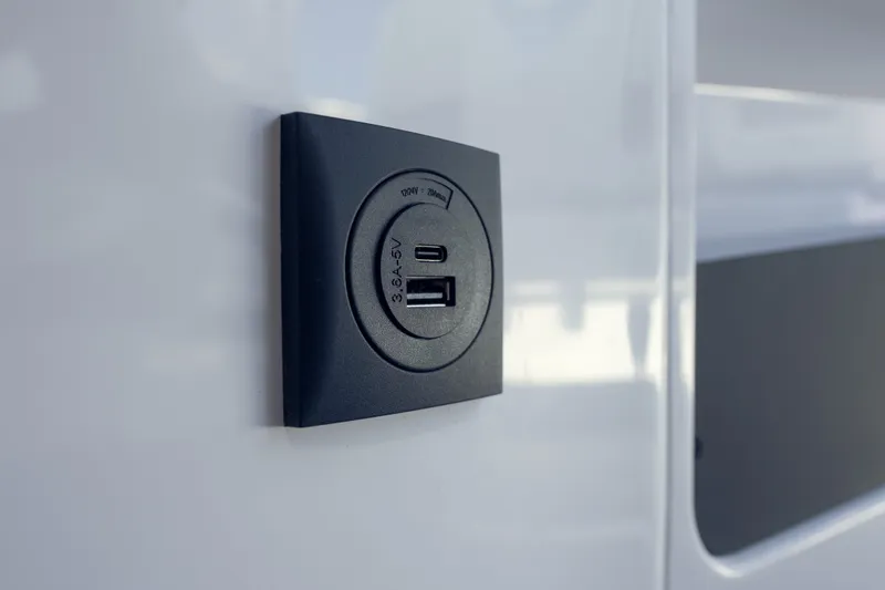 Slide: The Image of USB charging port on 2027 Axopar 29 XC Cross Cabin boat interior. - 22