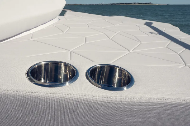 Slide: The Image of 2027 Axopar 29 XC Cross Cabin boat with stylish white upholstery and cup holders. - 20