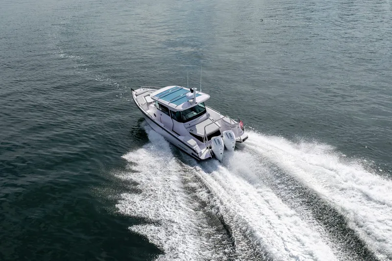 Slide: The Image of 2027 Axopar 29 XC Cross Cabin boat cruising on open water. - 6
