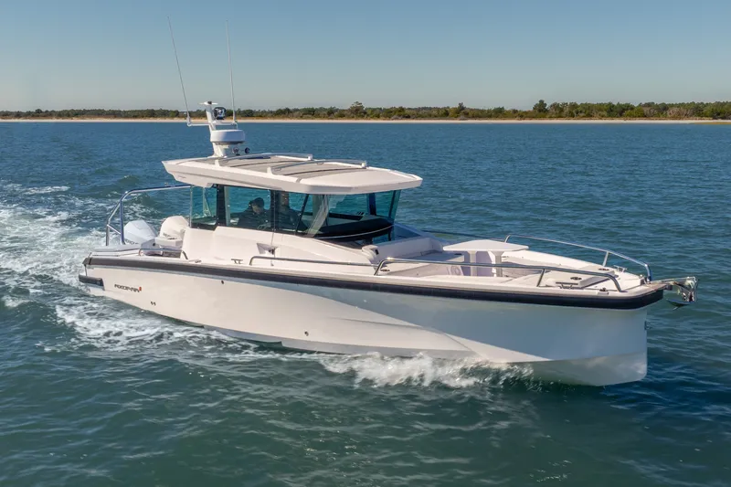 Slide: The Image of 2027 Axopar 29 XC Cross Cabin cruising on open water. - 1