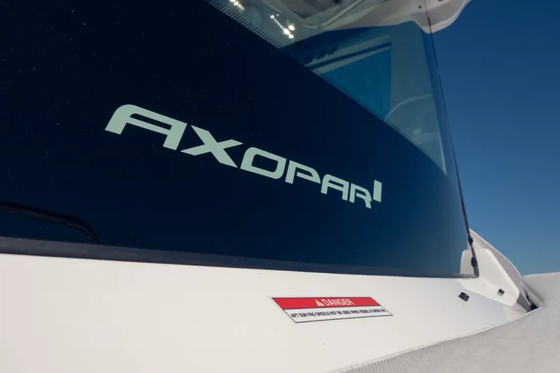 Slide: The Image of 2027 Axopar 29 XC Cross Cabin boat with logo on window. - 19
