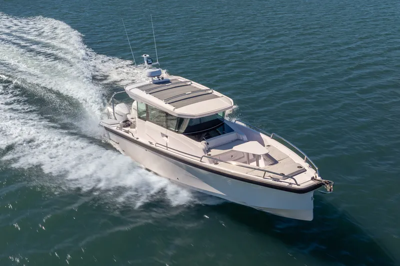 The Image of 2027 Axopar 29 XC Cross Cabin cruising on open water, showcasing sleek design and performance. - 0
