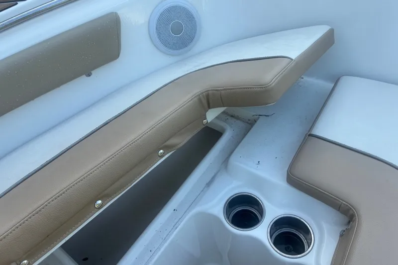 Slide: The Image of 2020 Key West 203 FS boat interior with beige seating and cup holders. - 44
