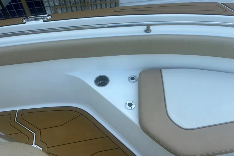 Slide: The Image of Interior view of a 2020 Key West 203 FS boat, featuring tan seating and deck details. - 45