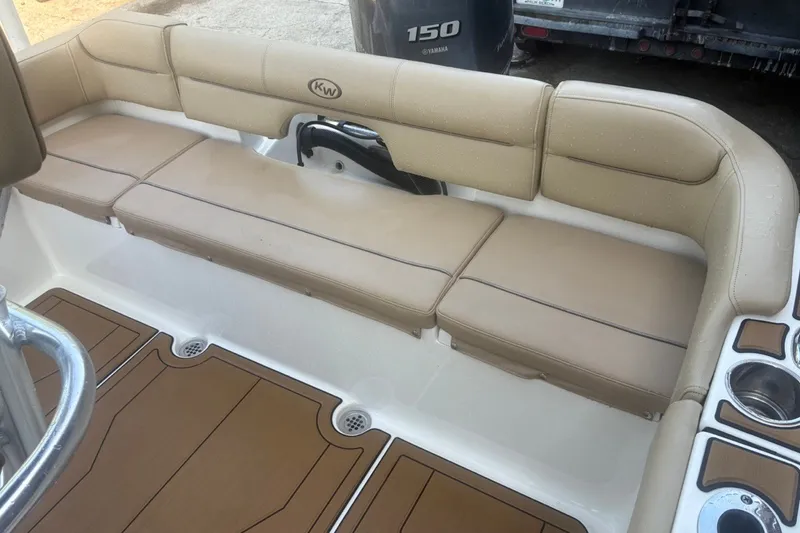 Slide: The Image of 2020 Key West 203 FS boat interior with beige seating and cup holders. - 48