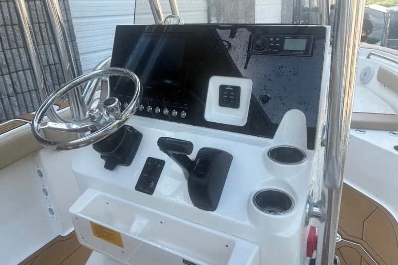 Slide: The Image of 2020 Key West 203 FS boat dashboard with steering wheel and control panel. - 24
