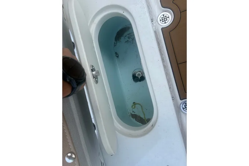 Slide: The Image of Livewell compartment on a 2020 Key West 203 FS boat, partially filled with water. - 55