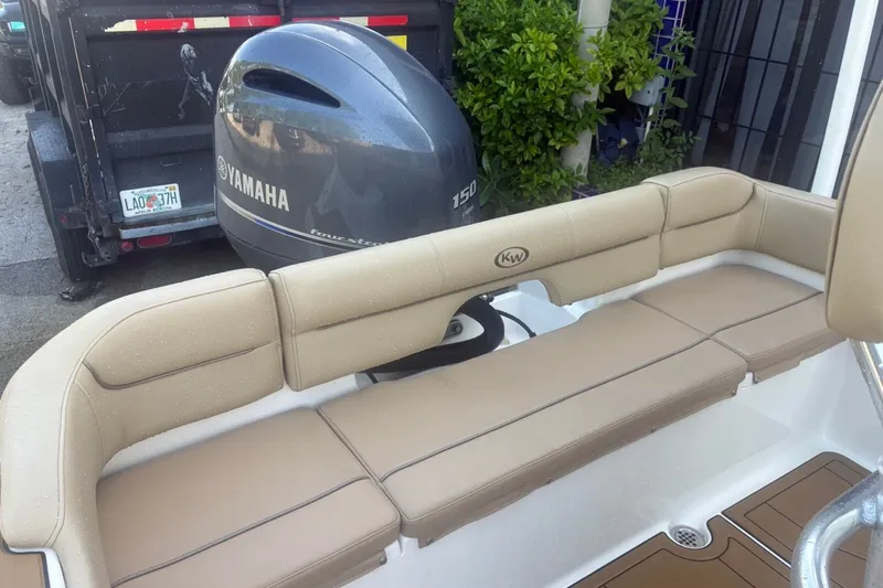 Slide: The Image of 2020 Key West 203 FS boat with Yamaha 150 engine, featuring tan seating. - 22