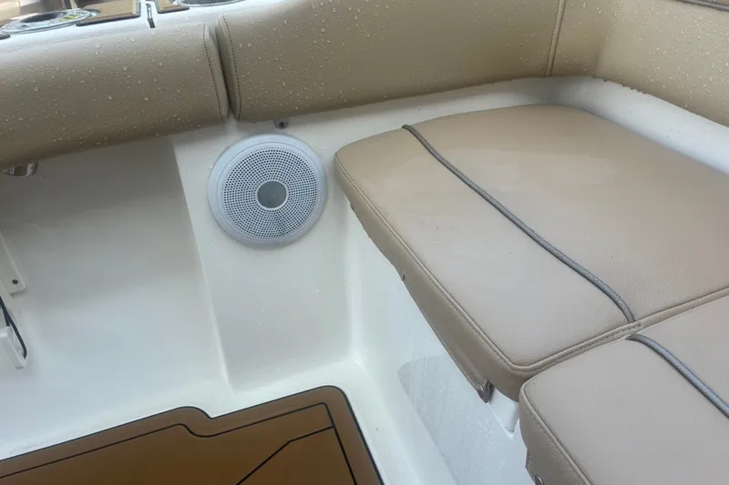 Slide: The Image of 2020 Key West 203 FS boat interior with cushioned seating and speaker. - 59