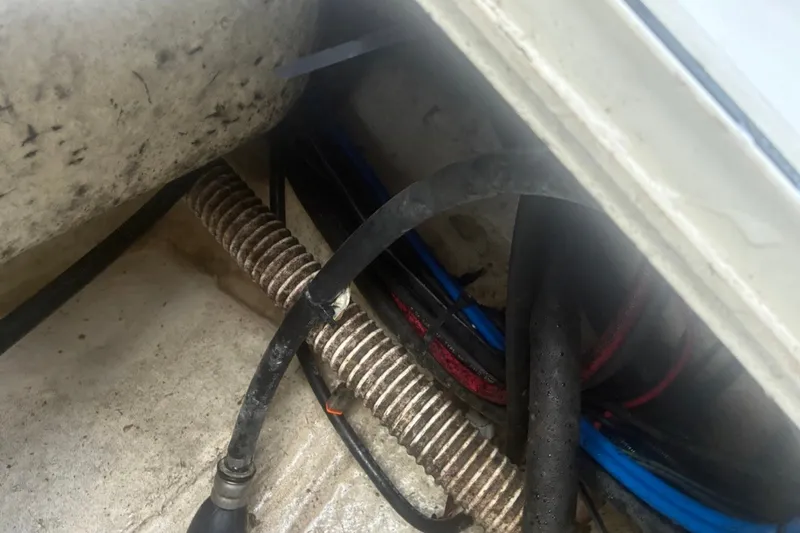 Slide: The Image of Wiring and hoses inside a 2020 Key West 203 FS boat compartment. - 32