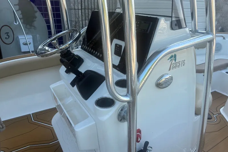 Slide: The Image of 2020 Key West 203 FS boat console with steering wheel and controls. - 26