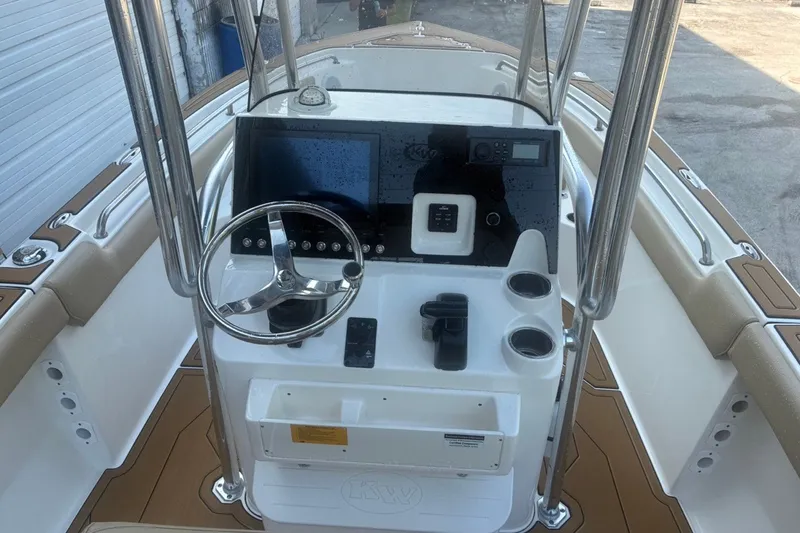 Slide: The Image of 2020 Key West 203 FS boat console with steering wheel and navigation controls. - 35
