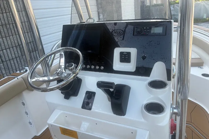 Slide: The Image of 2020 Key West 203 FS boat dashboard with steering wheel and controls. - 25