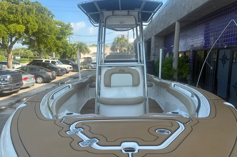 Slide: The Image of 2020 Key West 203 FS boat with tan seating and sleek design, parked outdoors. - 18