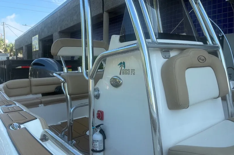 Slide: The Image of 2020 Key West 203 FS boat interior with beige seating and chrome details. - 21