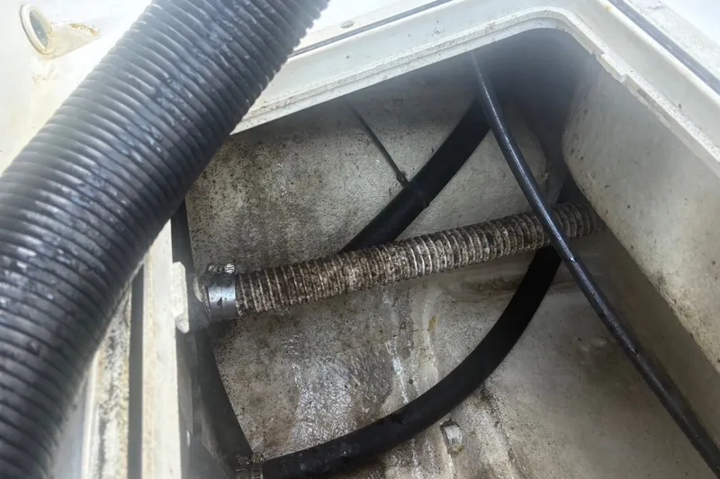 Slide: The Image of Bilge area of 2020 Key West 203 FS boat showing hoses and fittings. - 31