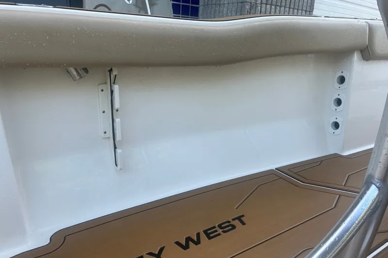 Slide: The Image of 2020 Key West 203 FS boat interior with tan seating and deck details. - 57