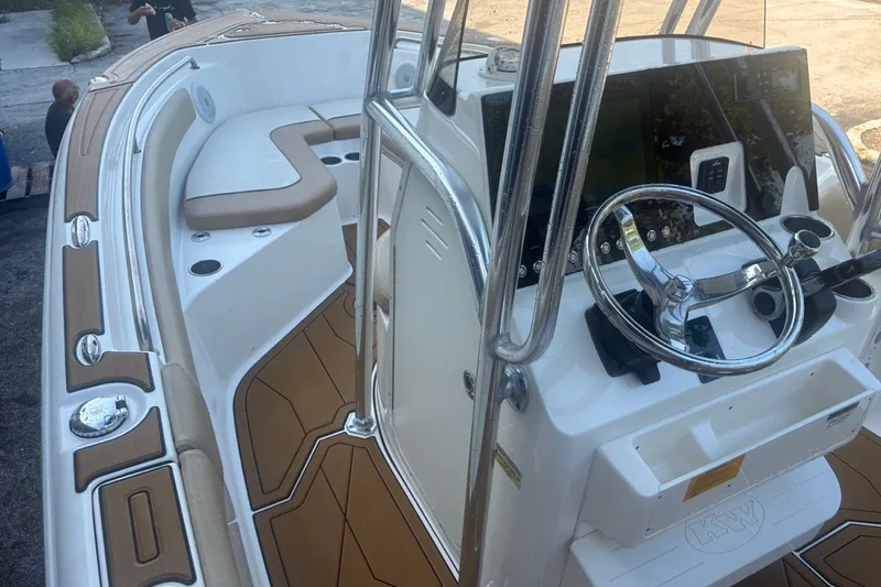 Slide: The Image of 2020 Key West 203 FS boat interior with steering console and seating area. - 47