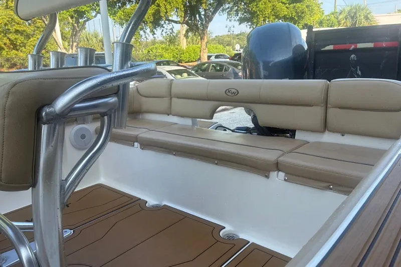 Slide: The Image of 2020 Key West 203 FS boat interior with tan seating and stainless steel fixtures. - 15