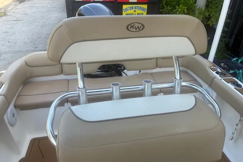 Slide: The Image of 2020 Key West 203 FS boat interior with beige seating and rod holders. - 50