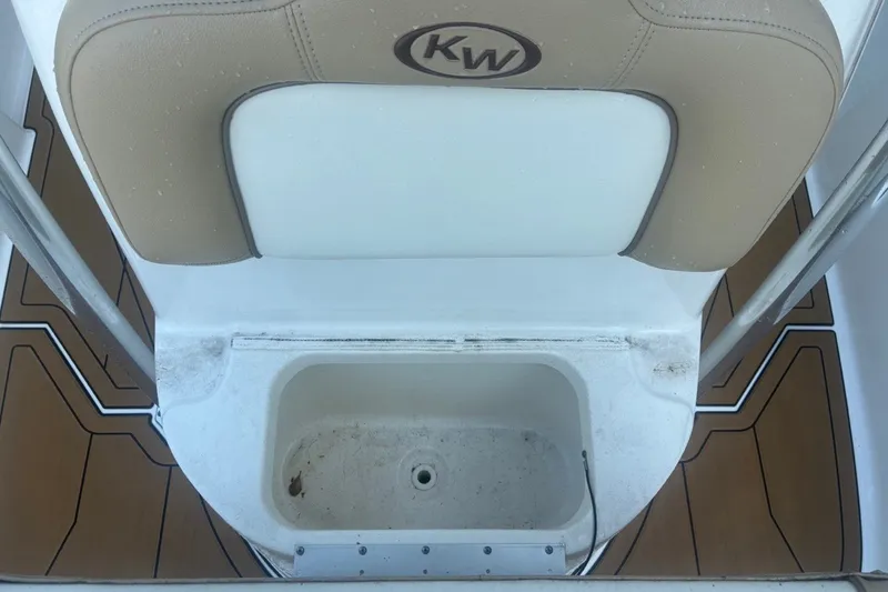 Slide: The Image of 2020 Key West 203 FS boat seat with storage compartment, featuring tan and white upholstery. - 39