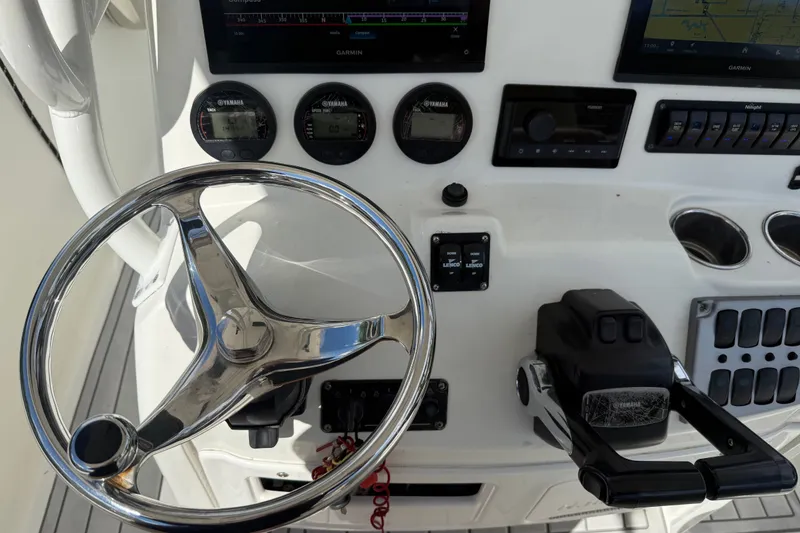 Slide: The Image of Control panel of a 2015 NauticStar 2500XS Offshore boat with steering wheel and gauges. - 27