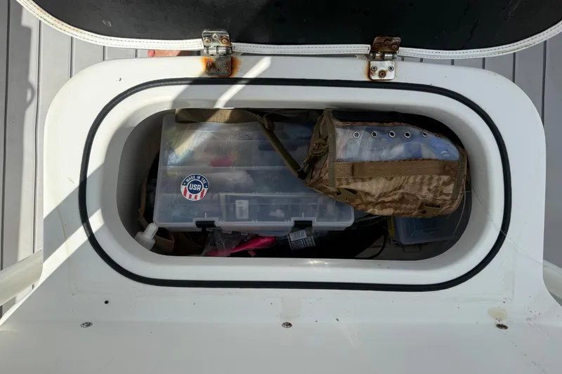 Slide: The Image of Storage compartment on a 2015 NauticStar 2500XS Offshore boat with fishing gear. - 51