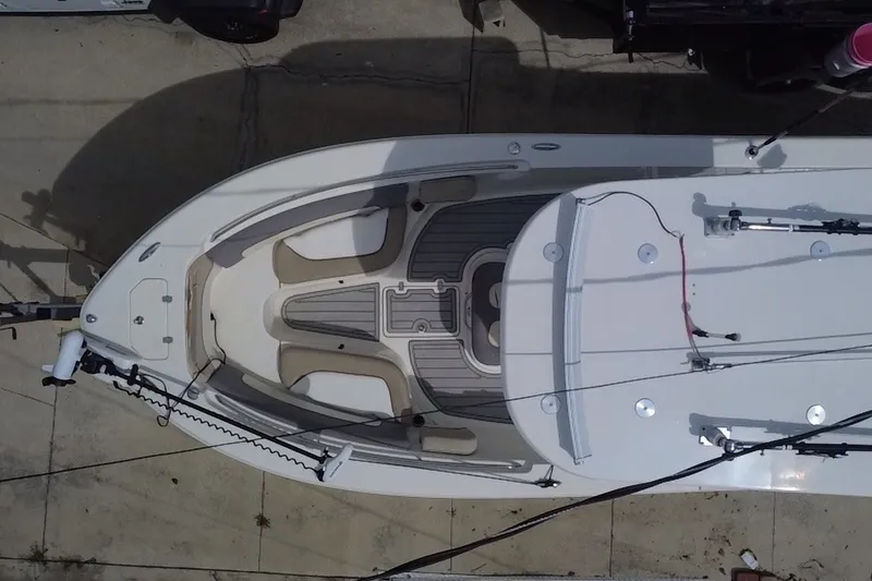 Slide: The Image of Top view of a 2015 NauticStar 2500XS Offshore boat docked on concrete. - 19