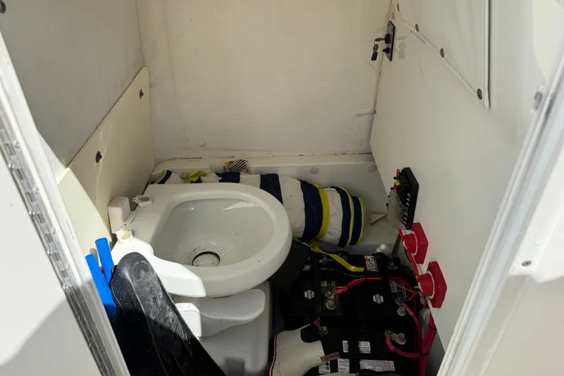 Slide: The Image of Interior of 2015 NauticStar 2500XS Offshore boat showing sink and battery compartment. - 45