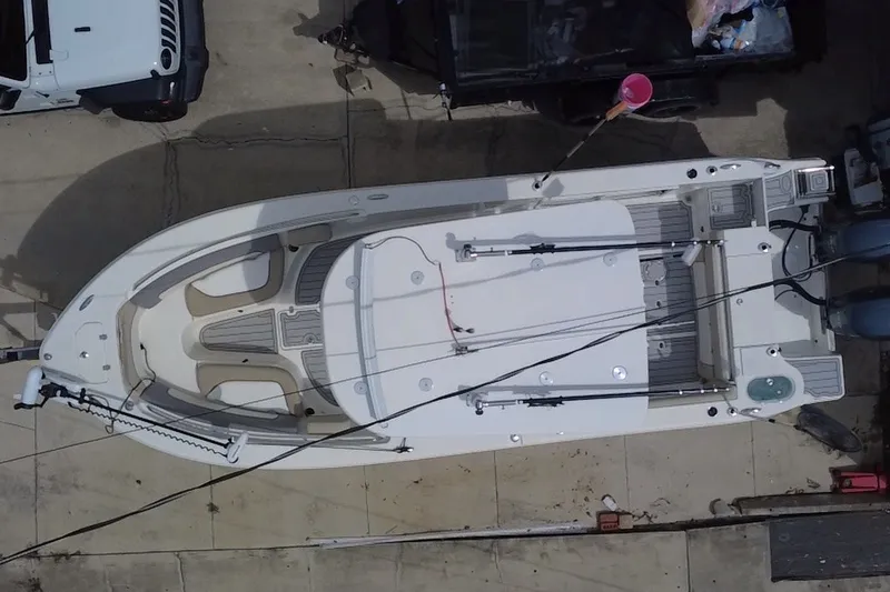 Slide: The Image of Overhead view of a 2015 NauticStar 2500XS Offshore boat docked on concrete. - 18