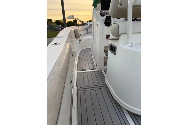 Slide: The Image of 2015 NauticStar 2500XS Offshore boat interior with cushioned seating and sleek flooring. - 8