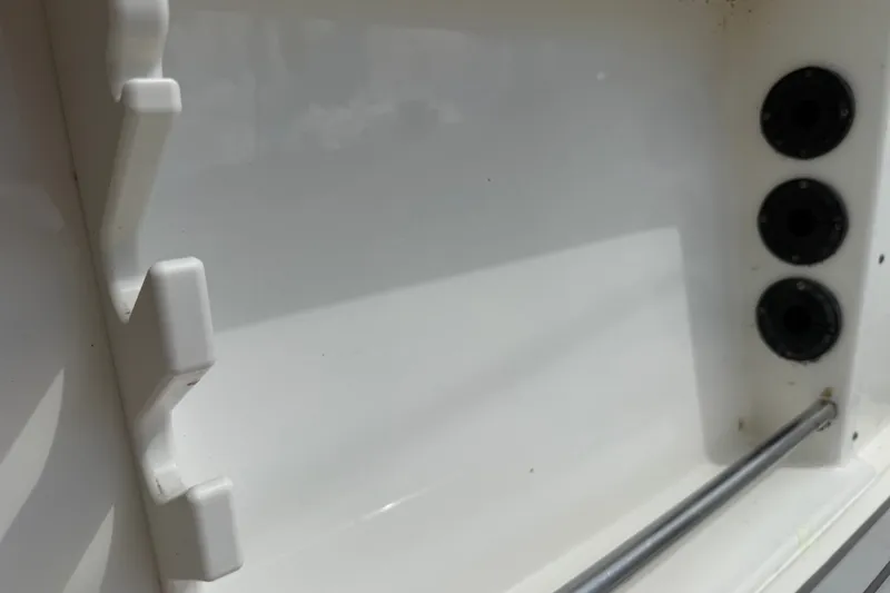 Slide: The Image of Interior detail of a 2015 NauticStar 2500XS Offshore boat, featuring rod holders. - 42