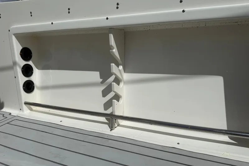 Slide: The Image of 2015 NauticStar 2500XS Offshore boat interior with rod holders and sleek design. - 41
