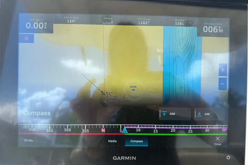 Slide: The Image of Garmin navigation display on 2015 NauticStar 2500XS Offshore boat, showing compass and map details. - 30