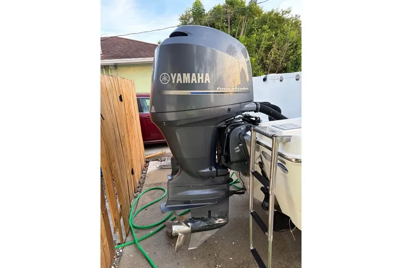 Slide: The Image of 2015 NauticStar 2500XS Offshore with Yamaha outboard motor in a driveway setting. - 4