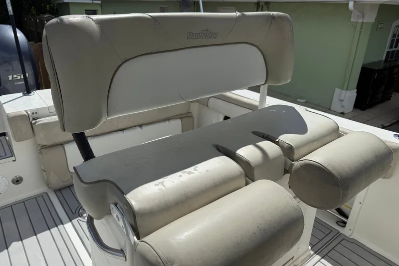 Slide: The Image of 2015 NauticStar 2500XS Offshore boat seating, featuring cushioned helm seats and a clean deck. - 24