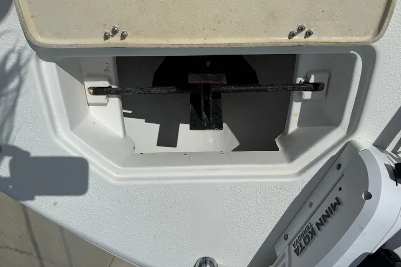 Slide: The Image of 2015 NauticStar 2500XS Offshore boat anchor compartment with Minn Kota trolling motor. - 36