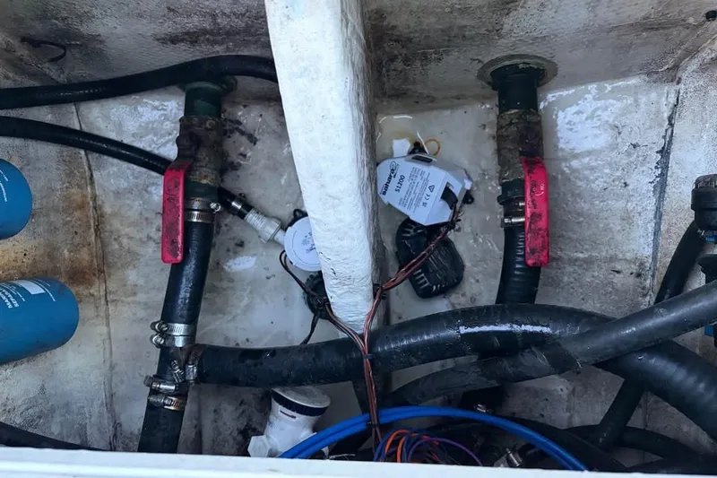 Slide: The Image of Bilge area of a 2015 NauticStar 2500XS Offshore boat with hoses and valves. - 12