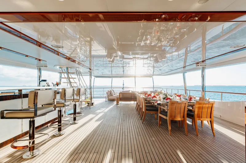 Slide: The Image of Luxurious 2016 Benetti Motoryacht deck with bar and dining area overlooking the ocean. - 50