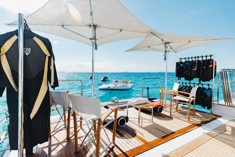 Slide: The Image of Luxurious 2016 Benetti Motoryacht deck with wetsuits, chairs, and ocean view. - 61