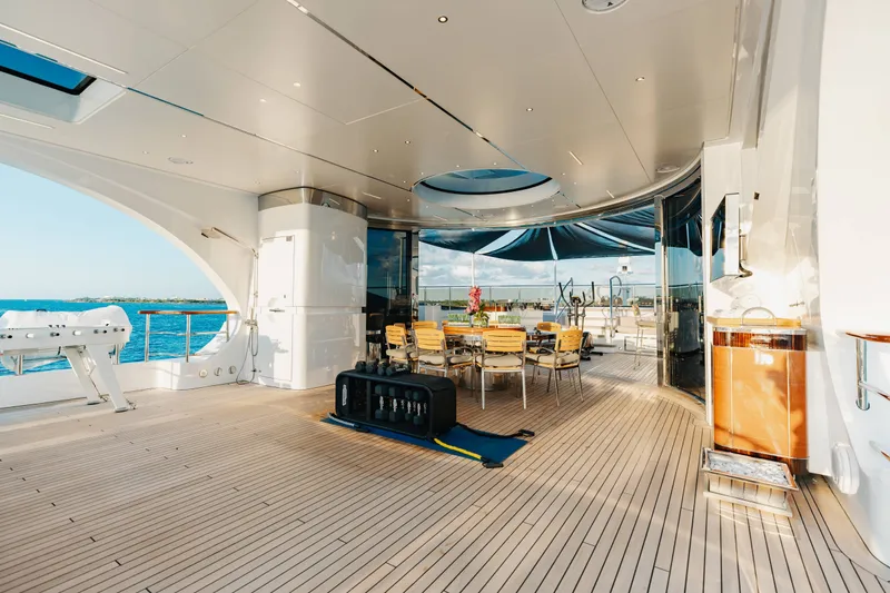 Slide: The Image of Luxurious 2016 Benetti Motoryacht deck with dining area, overlooking serene ocean views. - 53
