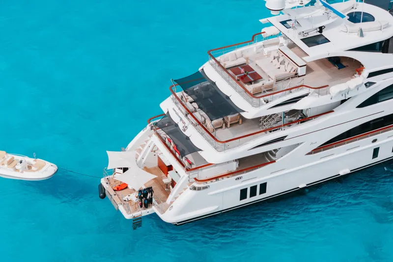 Slide: The Image of Luxurious 2016 Benetti Motoryacht on crystal-clear turquoise water, featuring spacious decks and elegant design. - 63