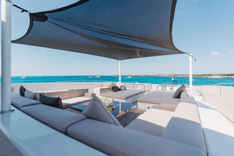 Slide: The Image of Luxurious 2016 Benetti Motoryacht deck with shaded seating, overlooking serene blue waters. - 58