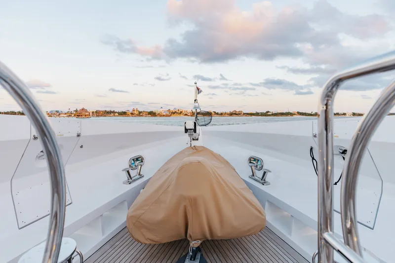 Slide: The Image of Bow view of 2016 Benetti Motoryacht with covered equipment, calm waters, and distant shoreline. - 60