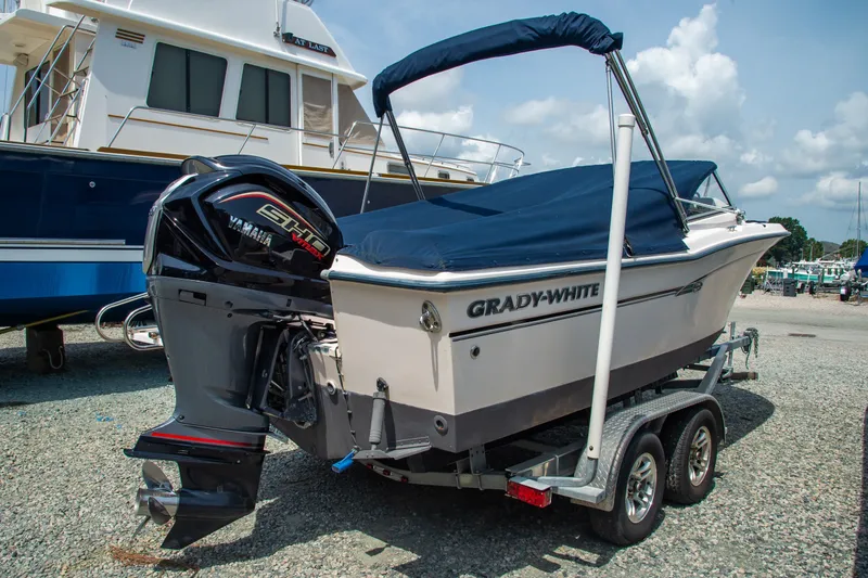 Slide: The Image of 2007 Grady-White Tournament 205 boat on trailer with Yamaha engine, covered and parked. - 14