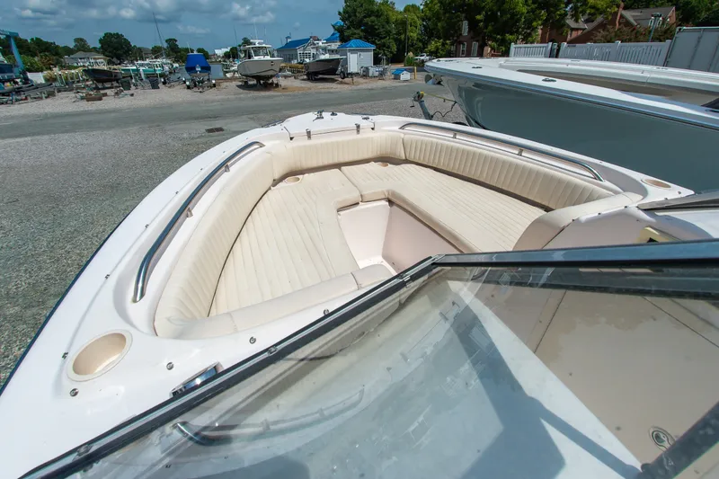 Slide: The Image of 2007 Grady-White Tournament 205 boat with spacious seating in a marina setting. - 6