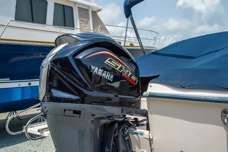 Slide: The Image of 2007 Grady-White Tournament 205 with Yamaha VMAX outboard engine, docked under blue cover. - 15