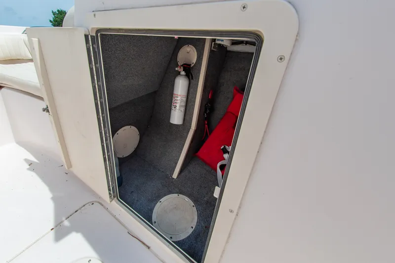 Slide: The Image of Storage compartment on a 2007 Grady-White Tournament 205 boat with safety equipment. - 4